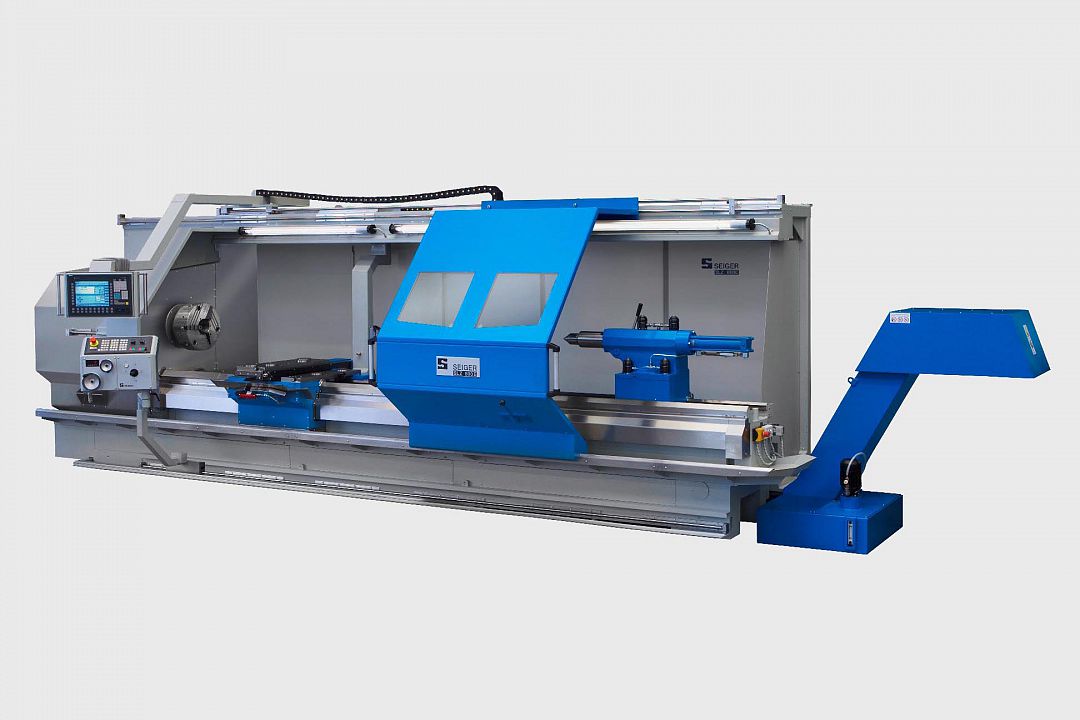 Machine in stud frame paneling for better accessibility and a larger workspace, following safety door coupled to the support, chuck protection hood separate, control cabinet as a separate cabinet